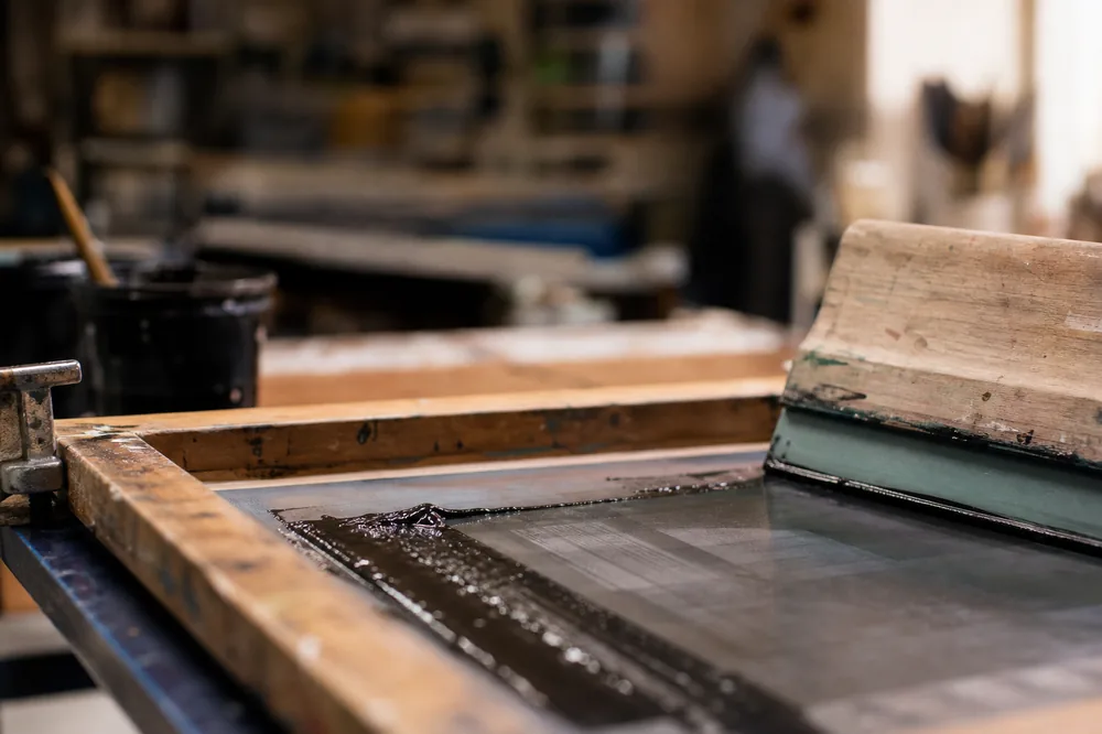 Screen printing equipment — frame, mesh, and squeegee in a production workshop